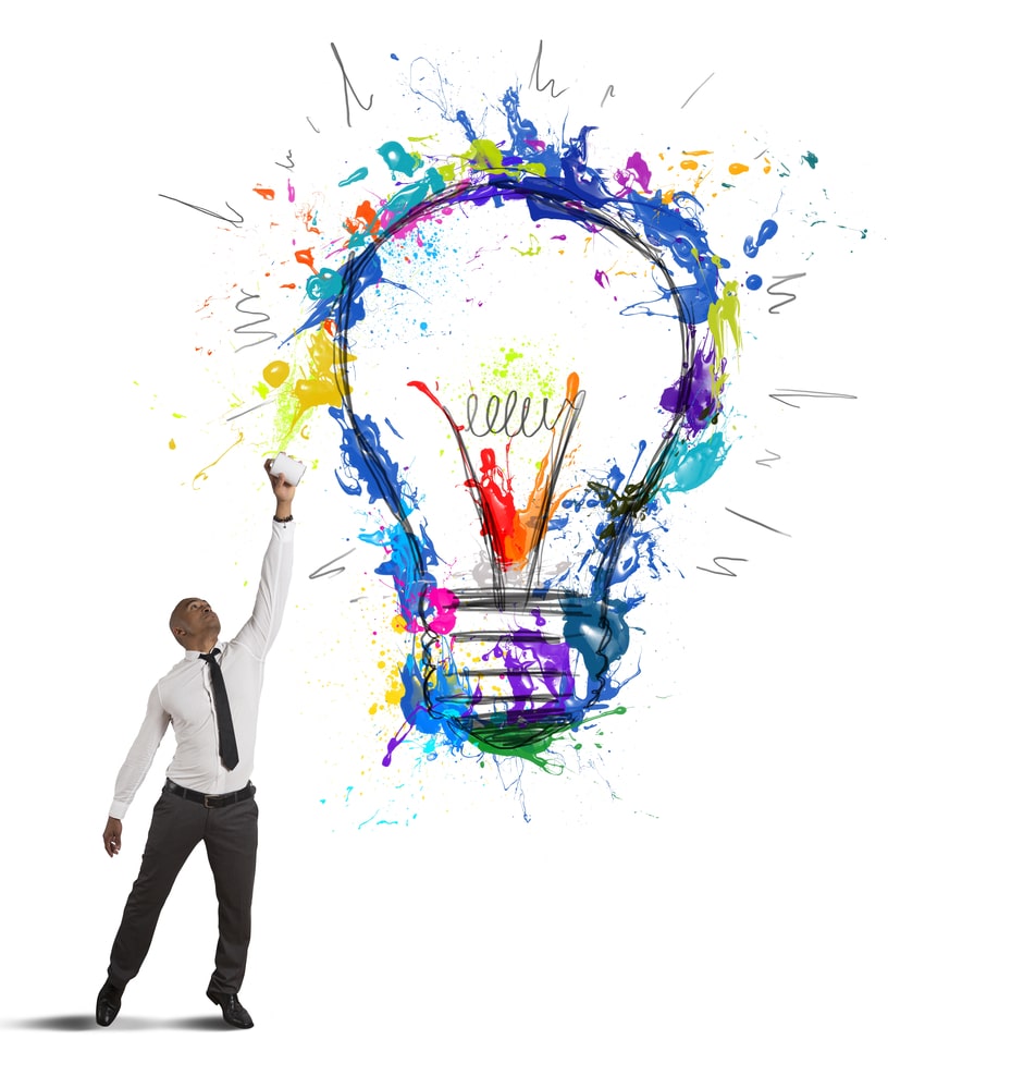 A person painting a very beautiful and color light bulb of all different colors. They're inspired by their life vision